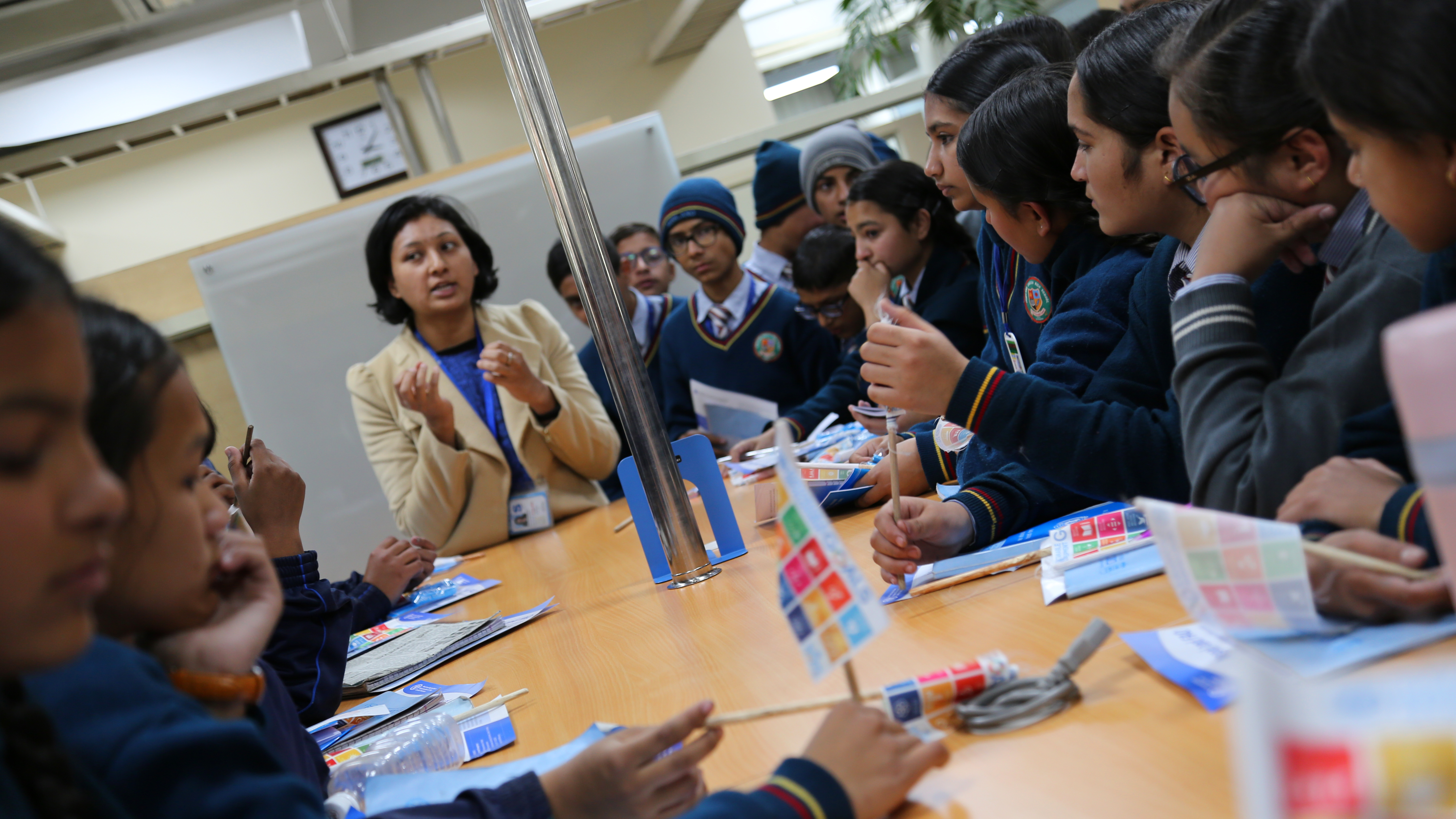 A woman lectures a group of people